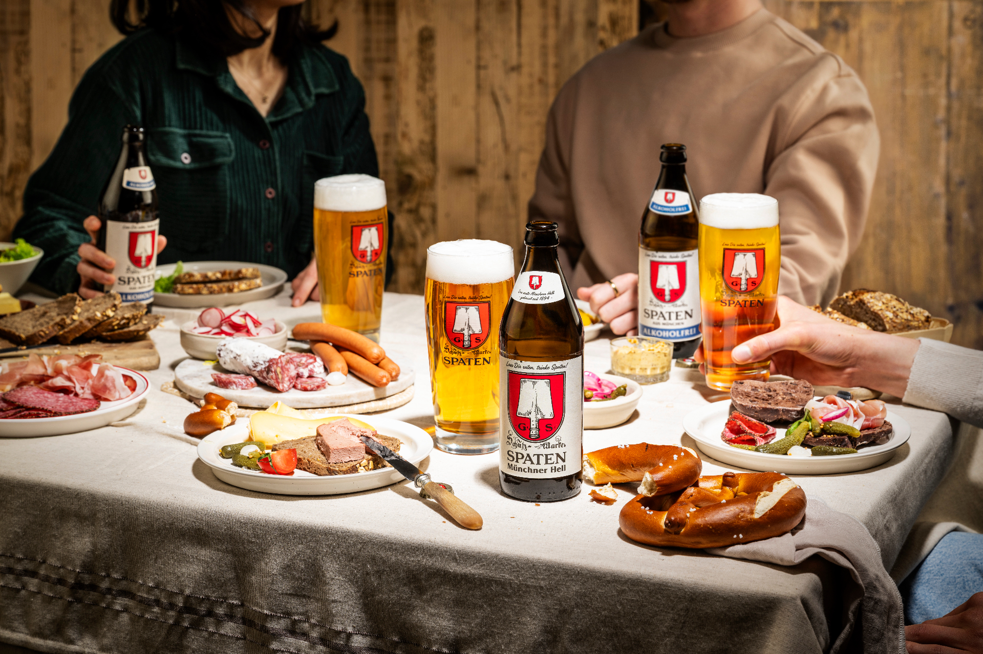 Set table with Spaten beer, pretzels and snacks in a festival-tent atmosphere